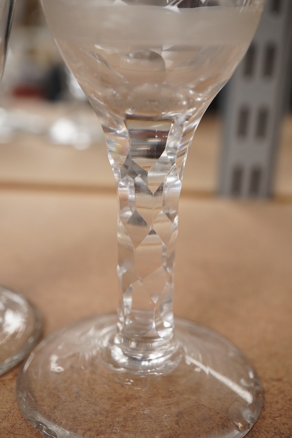 Four Georgian wine glasses, three with engraved bowls, three with faceted stems, and one with an air twist knopped stem and stepped foot, tallest 16cm